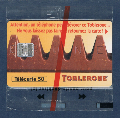 Télécarte téléphonique Française. Cinquante unités neuves sous blister officiel. Date 09 / 1995. Puce SC7. Lot  578741977 + C 59053426 en rouge. Descriptif: Toblerone.